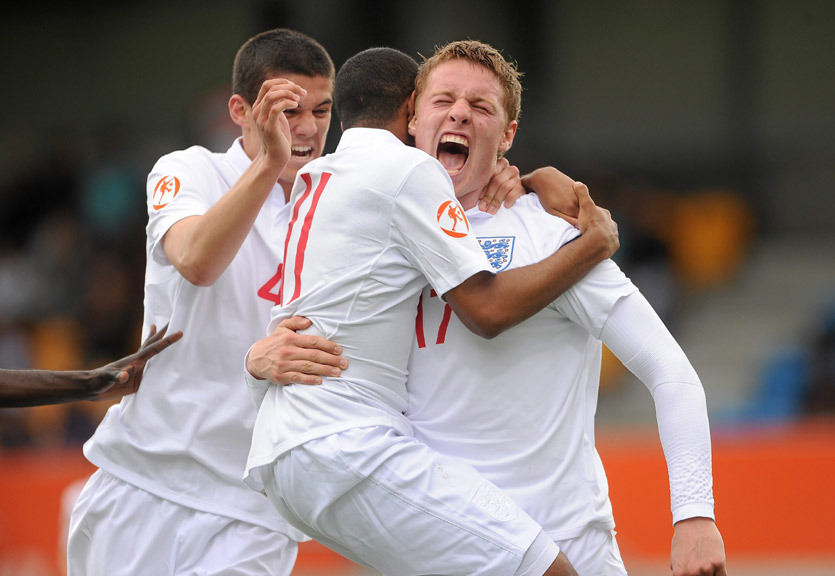 Connor Wickham (right) is congratulated by Conor Coady (left) and Rob Hall after giving England the lead against France.